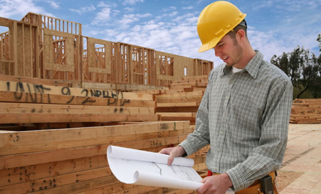 construction worker looking at plans